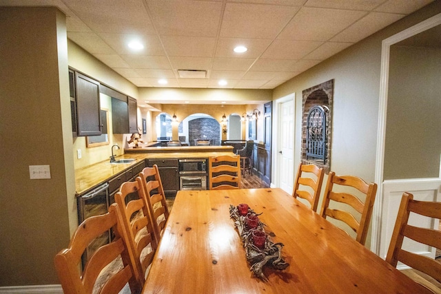 7380 Vassar Rd, Grand Blanc, MI 48439 - dining area with a drop ceiling, wood finished floors, recessed lighting, and wainscoting