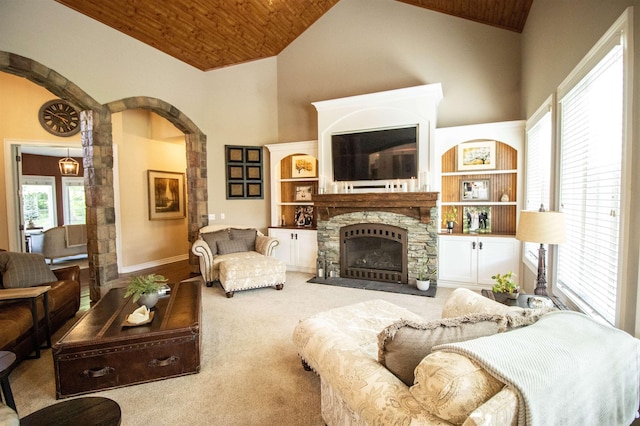 7380 Vassar Rd, Grand Blanc, MI 48439 - living area with arched walkways, wood ceiling, carpet floors, a fireplace, and high vaulted ceiling