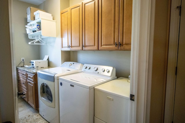 7380 Vassar Rd, Grand Blanc, MI 48439 - washroom featuring separate washer and dryer, cabinet space, and light tile patterned floors