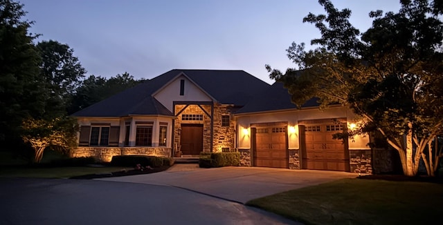 7380 Vassar Rd, Grand Blanc, MI 48439 - view of front facade with stone siding, a garage, concrete driveway, and stucco siding