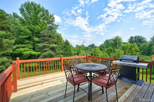 838 Star Dr, Davison, MI 48423 - deck featuring grilling area, outdoor dining space, and a forest view