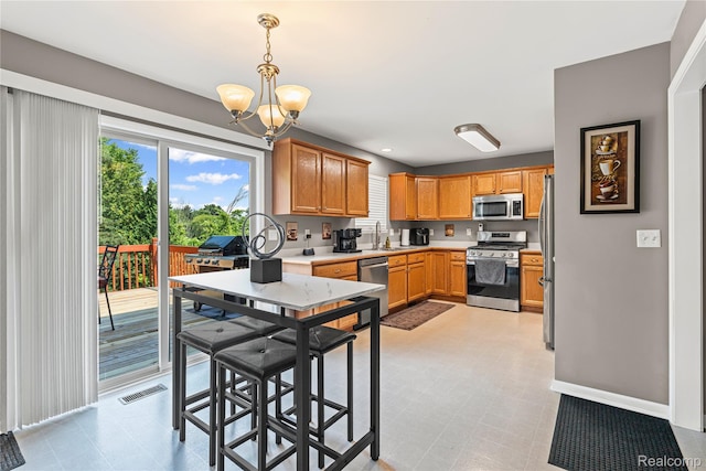 838 Star Dr, Davison, MI 48423 - kitchen with stainless steel appliances, a chandelier, light countertops, and light flooring