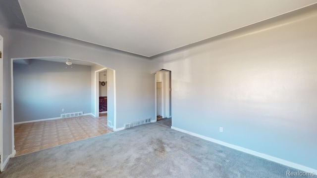 12660 Duchess St, Detroit, MI 48224 - carpeted empty room featuring arched walkways and a ceiling fan