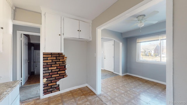 12660 Duchess St, Detroit, MI 48224 - kitchen with light countertops, ceiling fan, white cabinetry, and light flooring