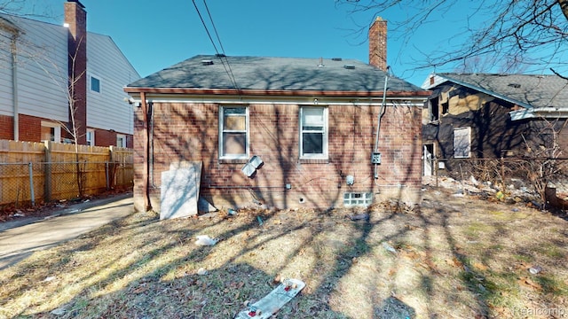 12660 Duchess St, Detroit, MI 48224 - back of house with a chimney, roof with shingles, and brick siding