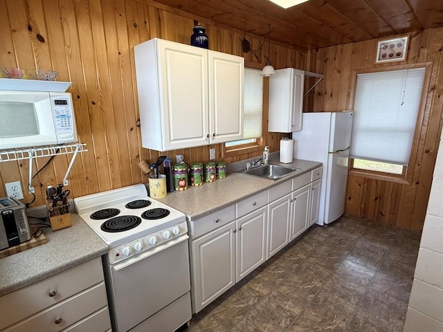 14450 Park Dr, Mecosta, MI 49332 - kitchen featuring white appliances, wood walls, wooden ceiling, white cabinetry, and light countertops
