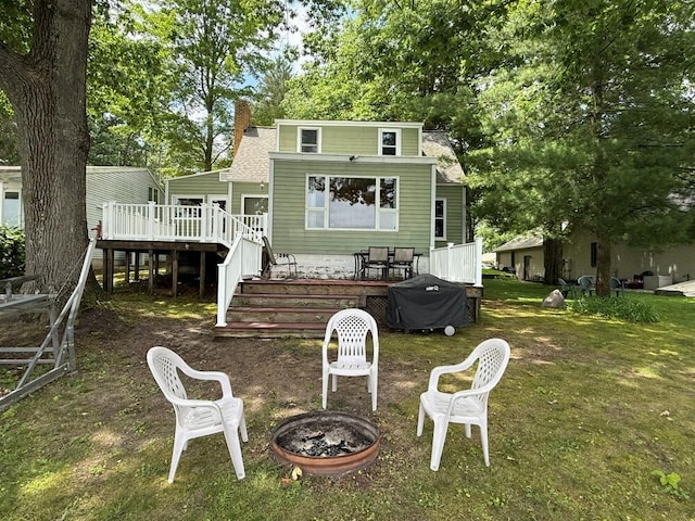 14450 Park Dr, Mecosta, MI 49332 - rear view of house featuring a fire pit, a chimney, a deck, stairs, and roof with shingles