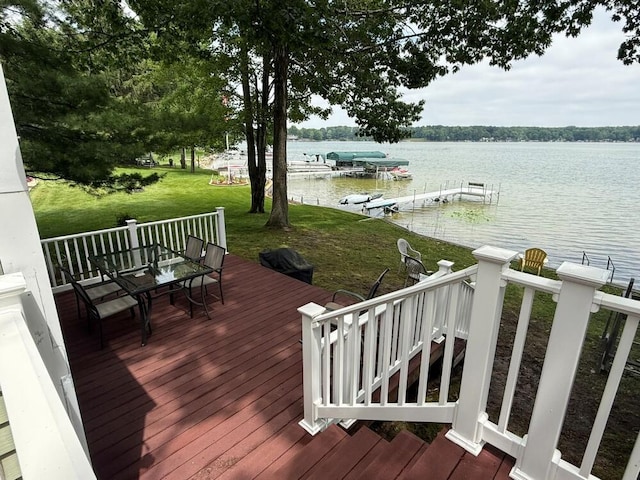 14450 Park Dr, Mecosta, MI 49332 - wooden deck with outdoor dining area, a yard, a water view, and a dock