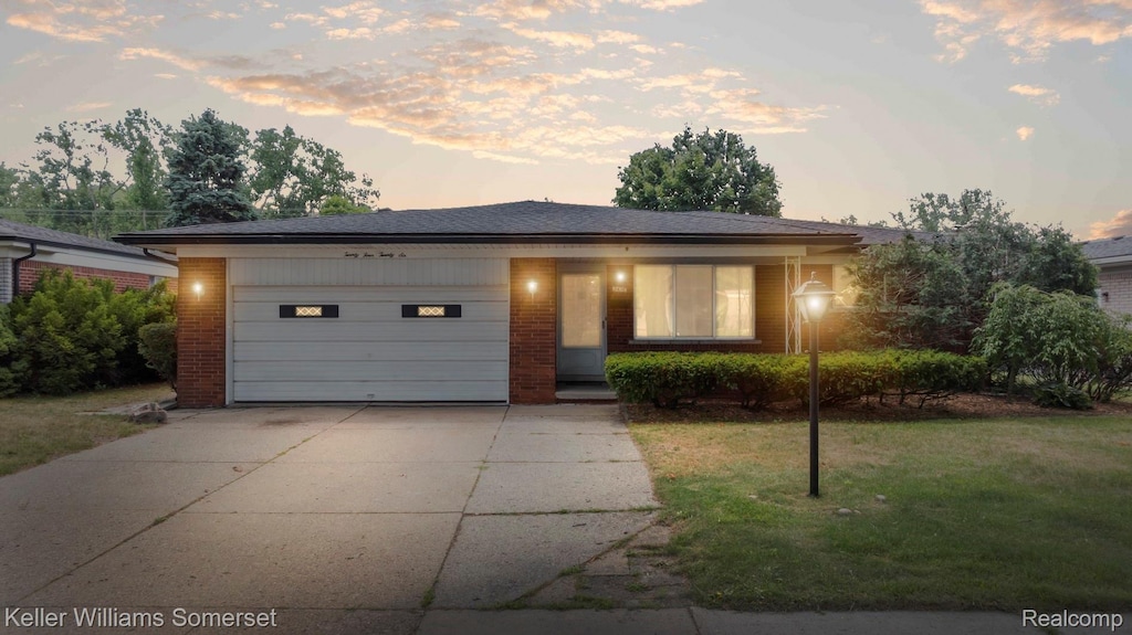 2426 Antonia Ln, Warren, MI 48091 - view of front of house featuring driveway, brick siding, a garage, and a front lawn