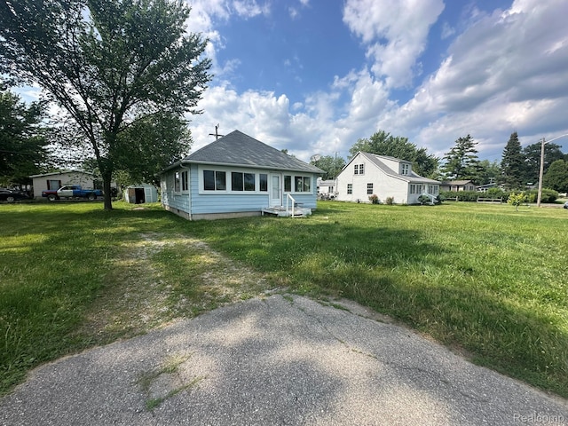 3363 Parkwood Ave, Monroe, MI 48162 - rear view of property with roof with shingles and a lawn