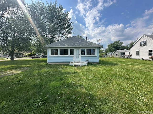 3363 Parkwood Ave, Monroe, MI 48162 - rear view of property featuring entry steps, roof with shingles, and a lawn
