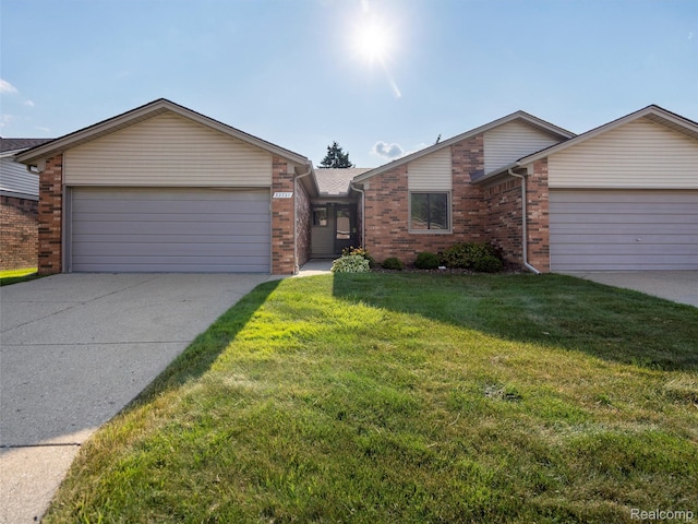 32721 Stoneybrook Ln, Macomb, MI 48026 - view of front of home featuring an attached garage, driveway, brick siding, and a front lawn