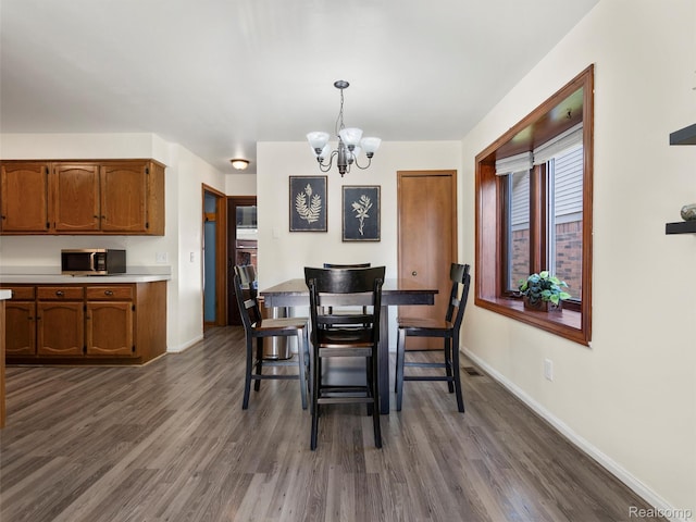 32721 Stoneybrook Ln, Macomb, MI 48026 - dining space featuring a chandelier and dark wood-style floors