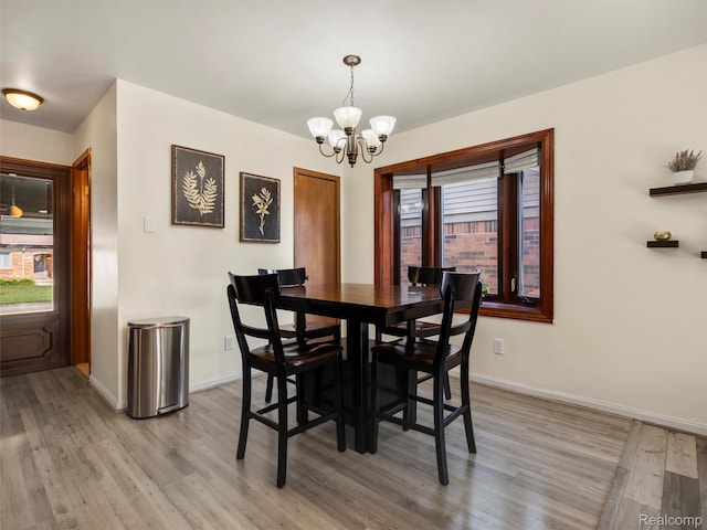 32721 Stoneybrook Ln, Macomb, MI 48026 - dining space featuring a chandelier and light wood-style flooring