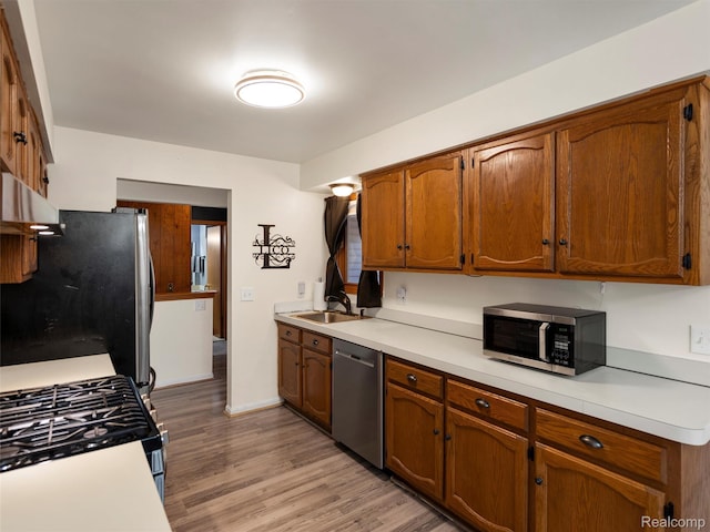 32721 Stoneybrook Ln, Macomb, MI 48026 - kitchen with stainless steel appliances, light wood finished floors, and light countertops