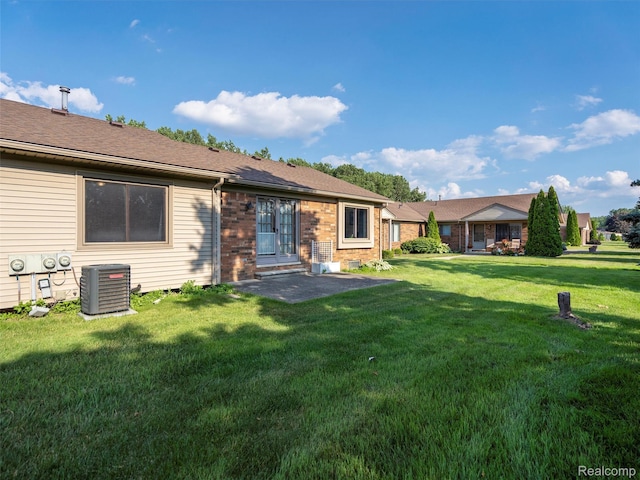 32721 Stoneybrook Ln, Macomb, MI 48026 - rear view of property featuring a yard, brick siding, and a patio