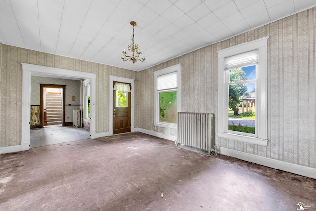 107 W Duncan St, Manchester, MI 48158 - entrance foyer with radiator heating unit, healthy amount of natural light, a chandelier, and wallpapered walls