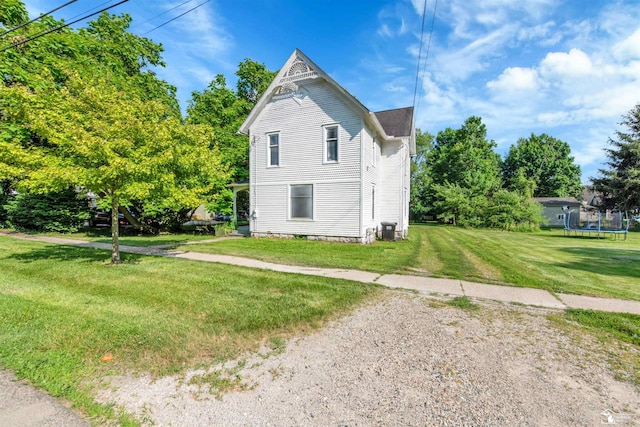 107 W Duncan St, Manchester, MI 48158 - view of home's exterior featuring a trampoline and a yard