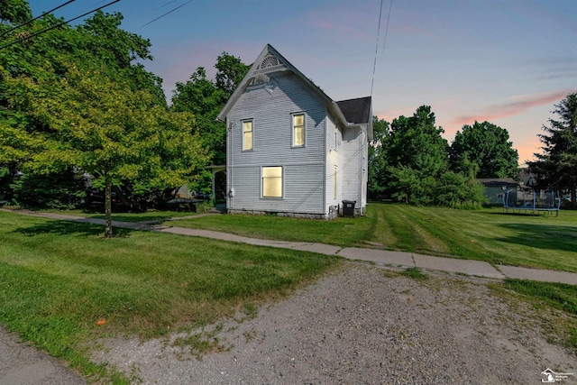107 W Duncan St, Manchester, MI 48158 - view of side of home featuring a yard and a trampoline