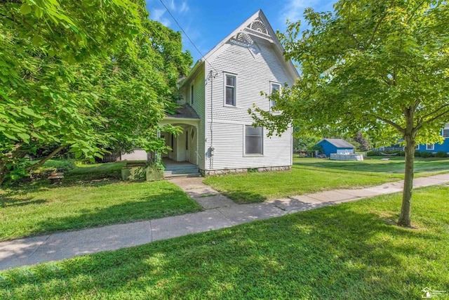 107 W Duncan St, Manchester, MI 48158 - victorian-style house with a front lawn and covered porch