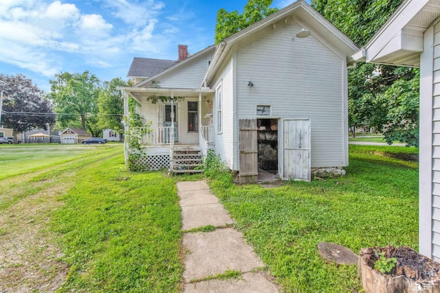 107 W Duncan St, Manchester, MI 48158 - view of front facade featuring a porch, a front yard, and a chimney