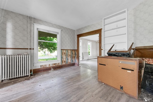 107 W Duncan St, Manchester, MI 48158 - unfurnished room featuring radiator, wallpapered walls, and wood finished floors