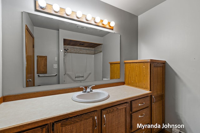 602 Elsa St, North Muskegon, MI 49445 - bathroom featuring vanity and a shower