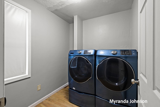 602 Elsa St, North Muskegon, MI 49445 - laundry area featuring washing machine and dryer and wood finished floors