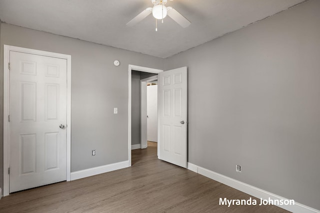 602 Elsa St, North Muskegon, MI 49445 - unfurnished bedroom with wood finished floors and ceiling fan