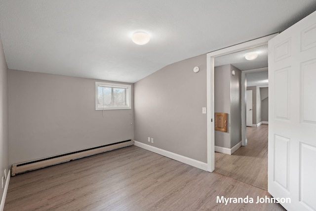 602 Elsa St, North Muskegon, MI 49445 - spare room featuring a baseboard heating unit, light wood-type flooring, and a smoke detector
