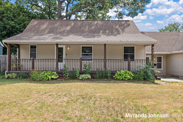 602 Elsa St, North Muskegon, MI 49445 - view of front of home featuring a porch, a front lawn, and roof with shingles