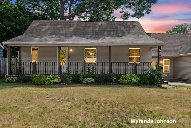602 Elsa St, North Muskegon, MI 49445 - view of front facade with a front lawn, covered porch, and roof with shingles