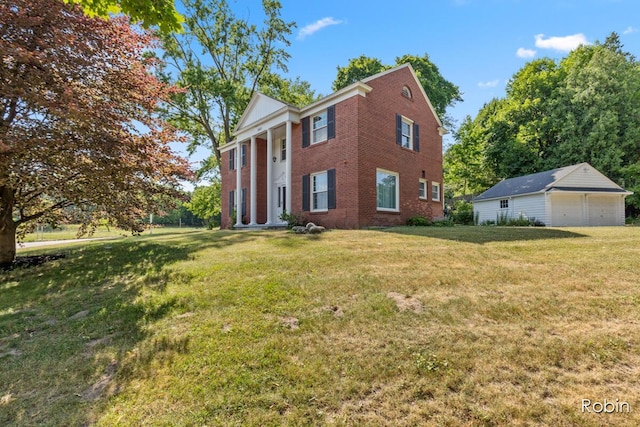 119 Bristol Ave NW, Grand Rapids, MI 49504 - view of side of home with a detached garage, brick siding, a lawn, and an outbuilding