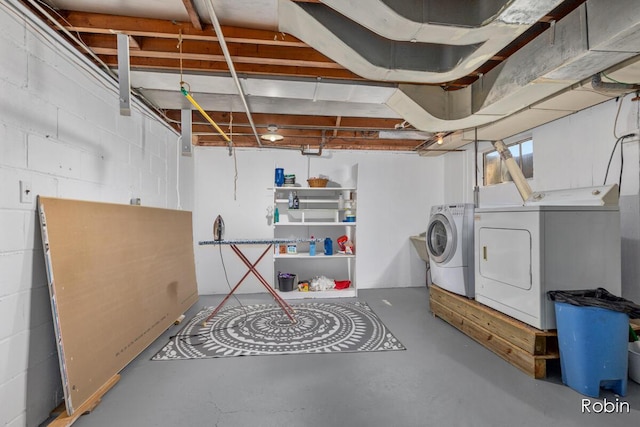 119 Bristol Ave NW, Grand Rapids, MI 49504 - unfinished below grade area featuring washing machine and dryer and concrete block wall