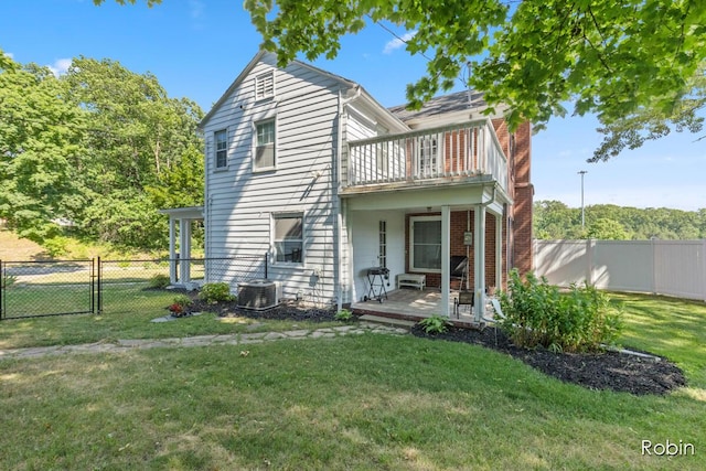 119 Bristol Ave NW, Grand Rapids, MI 49504 - back of house with a balcony, a fenced backyard, a chimney, and brick siding