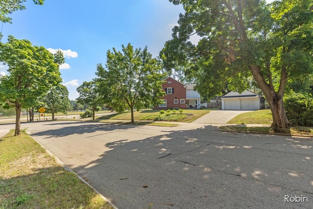 119 Bristol Ave NW, Grand Rapids, MI 49504 - view of front facade with driveway, an outbuilding, and a front lawn