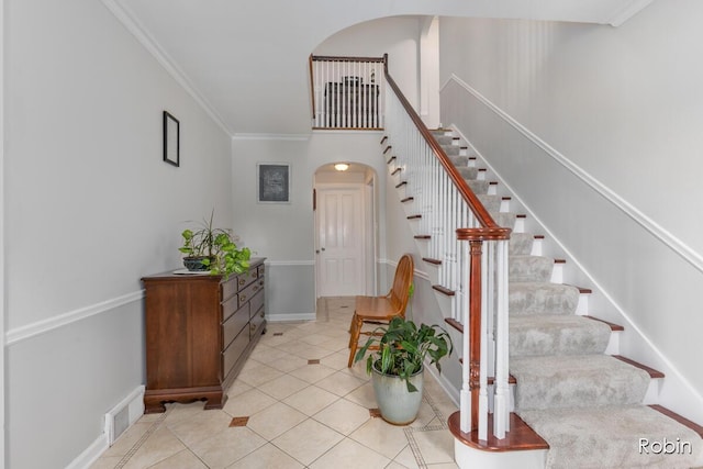 119 Bristol Ave NW, Grand Rapids, MI 49504 - stairway with arched walkways, tile patterned floors, and crown molding