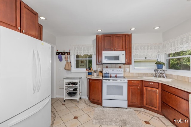 119 Bristol Ave NW, Grand Rapids, MI 49504 - kitchen with white appliances, light countertops, light tile patterned floors, recessed lighting, and backsplash