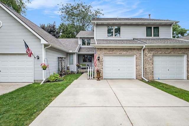 9379 Jamie Dr, Davison, MI 48423 - view of front facade featuring driveway, roof with shingles, a front lawn, and brick siding
