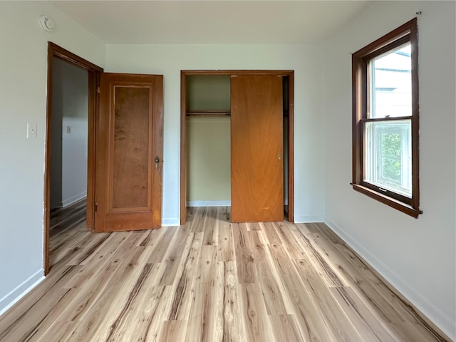 2839 128th Ave, Holland, MI 49424 - unfurnished bedroom with light wood-type flooring and a closet