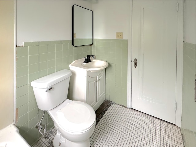 2839 128th Ave, Holland, MI 49424 - bathroom with tile walls, vanity, tile patterned floors, and wainscoting