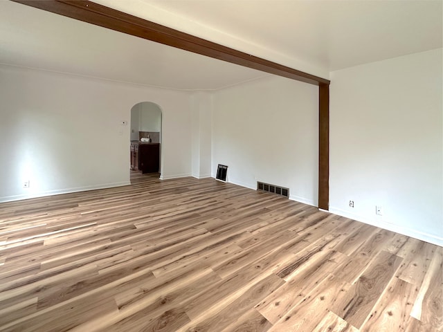 2839 128th Ave, Holland, MI 49424 - empty room with arched walkways and light wood-style flooring