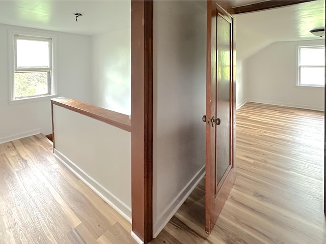 2839 128th Ave, Holland, MI 49424 - corridor with light wood-style flooring, an upstairs landing, and lofted ceiling