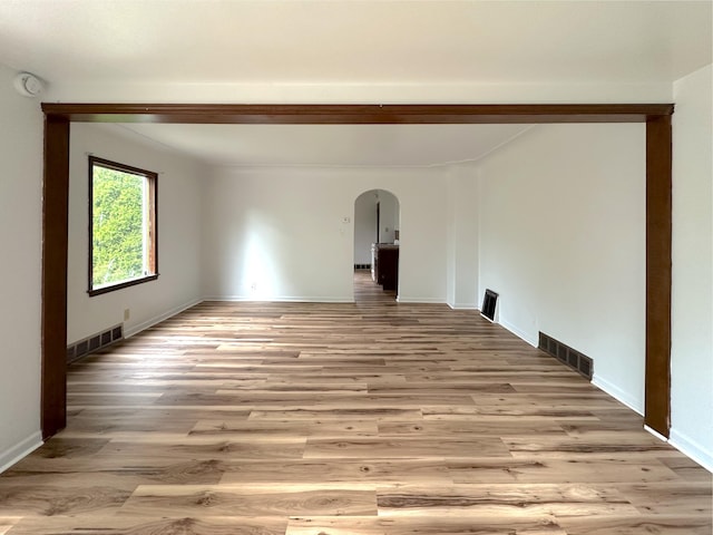 2839 128th Ave, Holland, MI 49424 - spare room featuring arched walkways, light wood-style flooring, and a smoke detector