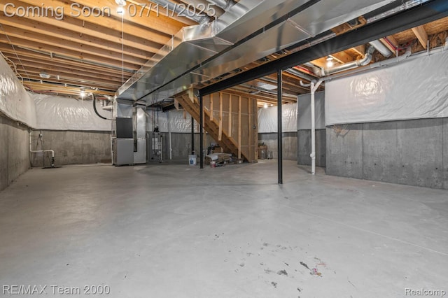 9019 Elbert Dr, Romulus, MI 48174 - unfinished basement with heating unit, stairs, and water heater