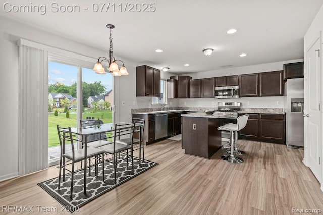 9019 Elbert Dr, Romulus, MI 48174 - kitchen featuring stainless steel appliances, dark brown cabinetry, a kitchen island, a kitchen bar, and recessed lighting