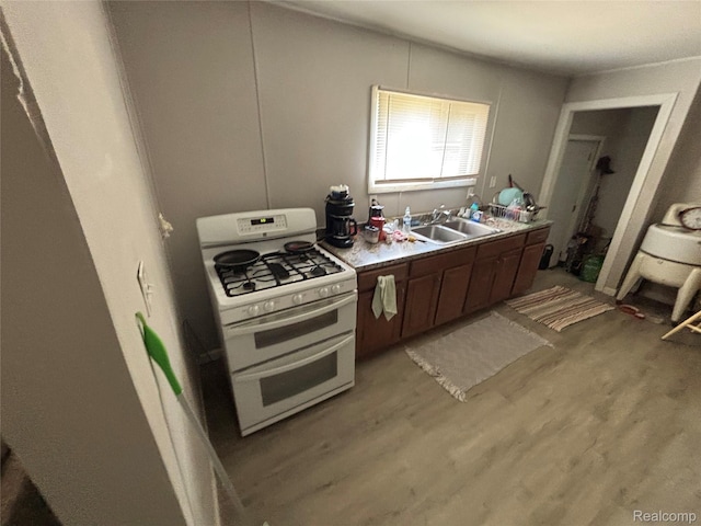 130 Meadle St, Warren, MI 48043 - kitchen featuring double oven range, light wood-type flooring, and light countertops