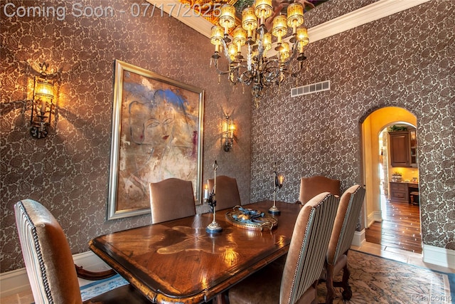 2756 Turtle Bluff Dr, Bloomfield Hills, MI 48302 - dining area featuring arched walkways, a chandelier, and ornamental molding
