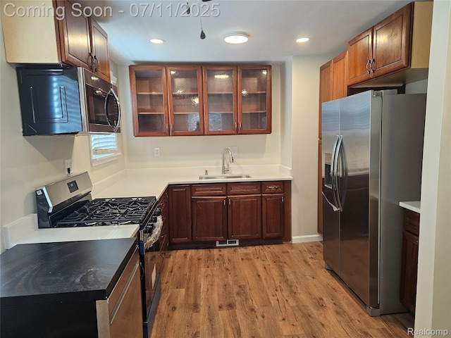 893 Leblanc St, Lincoln Park, MI 48146 - kitchen featuring appliances with stainless steel finishes, light wood finished floors, glass insert cabinets, and recessed lighting