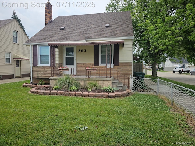 893 Leblanc St, Lincoln Park, MI 48146 - view of front of house featuring a shingled roof, a porch, stone siding, and a chimney